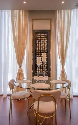 a dining room with two tables and chairs and a wine rack at Luxurious 2BR - Fully Upgraded - High-end facilities in Dubai