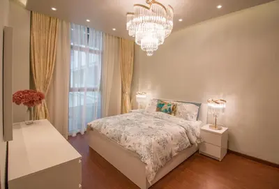 a bedroom with a bed and a chandelier at Luxurious 2BR - Fully Upgraded - High-end facilities in Dubai