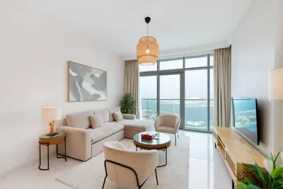 a living room with a couch and a tv at Sunrise Bay, Emaar Beachfront Dubai Harbour - Mint Stay in Dubai