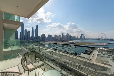 a balcony with chairs and a view of the city at Sunrise Bay, Emaar Beachfront Dubai Harbour - Mint Stay in Dubai