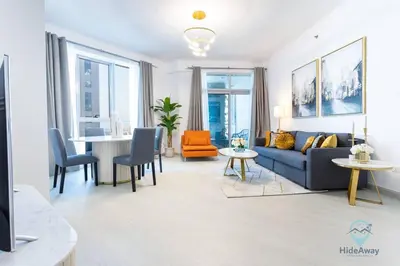 a living room with a couch and a table at Modern 2BR in the Heart of Dubai Marina in Dubai