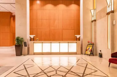 a lobby with a waiting area with a large wall at Prime Retreats - 29 Emaar Boulevard Downtown Dubai in Dubai
