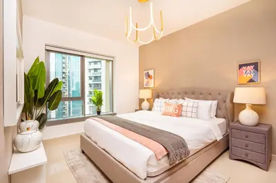 a bedroom with a large bed and a window at Prime Retreats - 29 Emaar Boulevard Downtown Dubai in Dubai