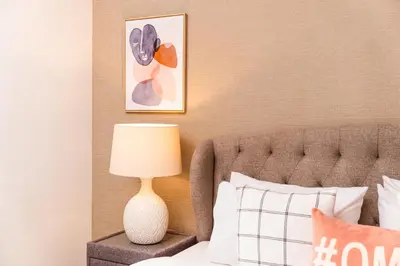a bedroom with a bed with a lamp next to it at Prime Retreats - 29 Emaar Boulevard Downtown Dubai in Dubai