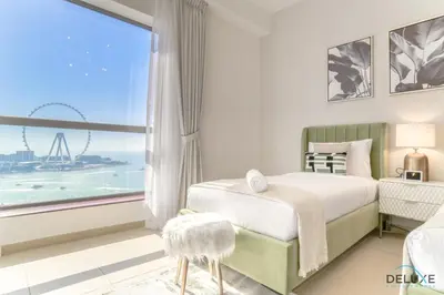 a bedroom with a bed and a large window at Impeccable 2BR at Bahar 2 JBR by Deluxe Holiday Homes in Dubai