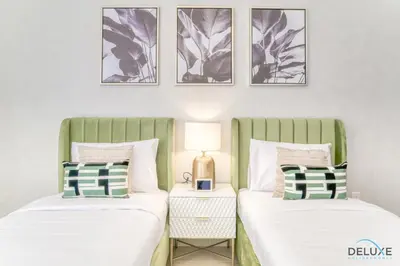 two beds sitting next to each other in a bedroom at Impeccable 2BR at Bahar 2 JBR by Deluxe Holiday Homes in Dubai