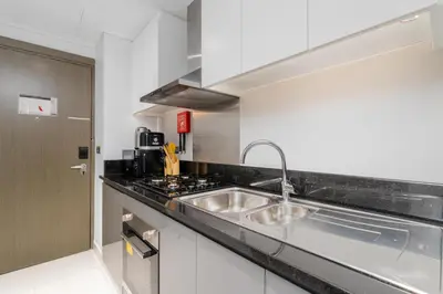 a kitchen with a sink and a stove at Vacay Lettings - Damac Prive studio in Dubai
