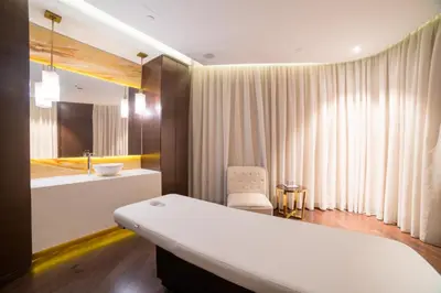 a bathroom with a bed and a sink and a tub at Vacay Lettings - Damac Prive studio in Dubai