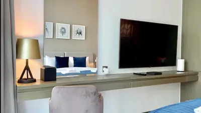 a bedroom with a large television and a bed at Vacay Lettings - Damac Prive studio in Dubai