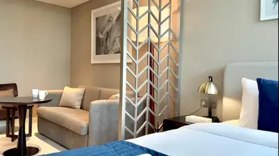 a living room with a bed and a couch at Vacay Lettings - Damac Prive studio in Dubai