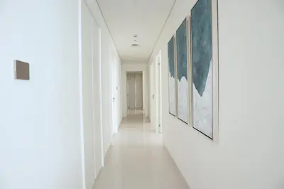 a hallway with paintings on the walls at HiGuests - Superlative apt with private beach access in Dubai