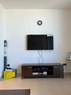 a flat screen tv hanging on a wall at OYO 887 Home A1607 Sobha Creek Vistas - 1BR in Dubai