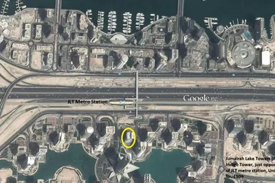 a map of a city with a yellow circle at La Buena Vida Holiday Homes - Luxe 1BD, boutique apt full lakeview 1m to Metro, Lake & Almas Tower in Dubai