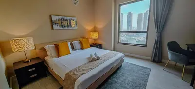 a bedroom with a large bed with a large window at La Buena Vida Holiday Homes, Luxe, 3BR with, full kitchen, Marina View, by JBR Beach, Tram & Marina in Dubai