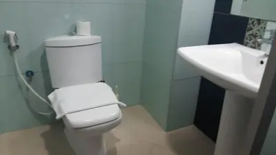 a bathroom with a white toilet and a sink at Vacay Lettings - Silicon Oasis Budget Friendly Studio in Dubai