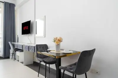 a dining room with a table and chairs at Vacay Lettings - Silicon Oasis Budget Friendly Studio in Dubai