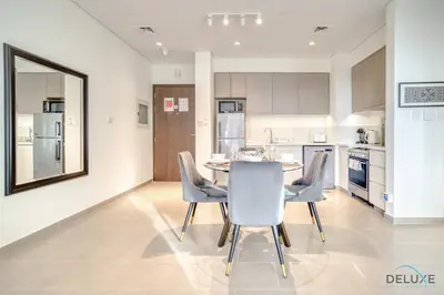 a kitchen with a table and chairs in a room at Graceful 1BR at Park Heights Dubai Hills MBR City by Deluxe Holiday Homes in Dubai