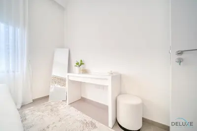 a bathroom with a white desk and a mirror at Graceful 1BR at Park Heights Dubai Hills MBR City by Deluxe Holiday Homes in Dubai