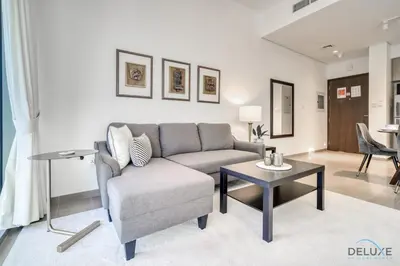 a living room with a couch and a table at Graceful 1BR at Park Heights Dubai Hills MBR City by Deluxe Holiday Homes in Dubai