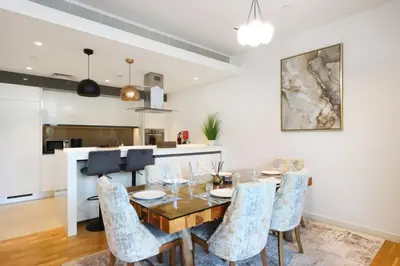 a dining room with a table and chairs at Livbnb - Upgraded 2BR, Near Shopping & Dining Hubs in Dubai