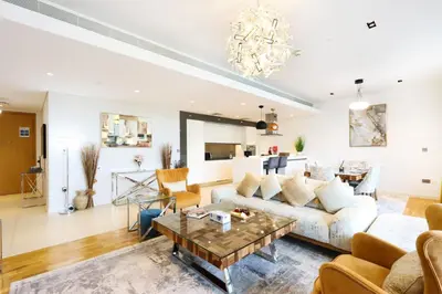 a living room with a couch and a table at Livbnb - Upgraded 2BR, Near Shopping & Dining Hubs in Dubai