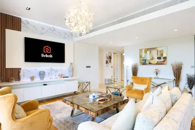a living room with a couch and a table at Livbnb - Upgraded 2BR, Near Shopping & Dining Hubs in Dubai