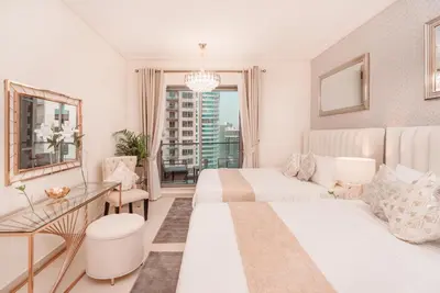 a hotel room with two beds and a desk at Elite Royal Apartment - Panoramic Full Burj Khalifa, Fountain & Skyline view - Imperial - 2 bedrooms & 1 open bedroom without partition in Dubai