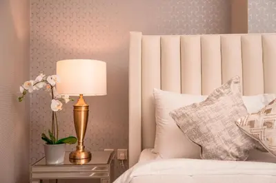 a bedroom with a bed and a lamp on a nightstand at Elite Royal Apartment - Panoramic Full Burj Khalifa, Fountain & Skyline view - Imperial - 2 bedrooms & 1 open bedroom without partition in Dubai