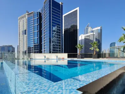 a swimming pool in a city with tall buildings at Trophy Elite Elegance Suites with Panaromic Burj Khalifa Views in Dubai