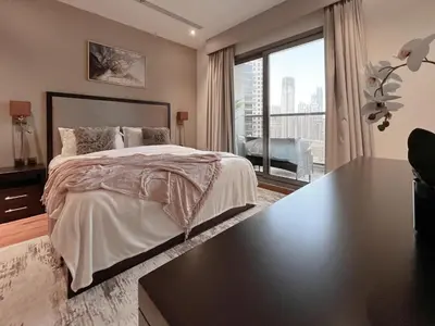a bedroom with a large bed and a large window at Trophy Elite Elegance Suites with Panaromic Burj Khalifa Views in Dubai