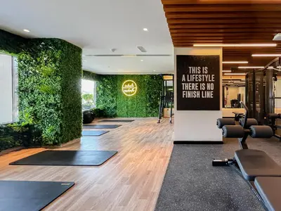 a gym with a green wall with yoga mats at Trophy Elite Elegance Suites with Panaromic Burj Khalifa Views in Dubai