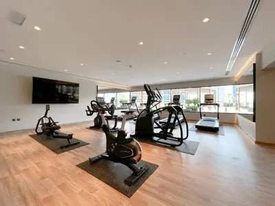 a gym with treadmills and exercise bikes in a room at Trophy Elite Elegance Suites with Panaromic Burj Khalifa Views in Dubai