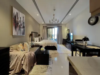 a living room with a couch and a bed at Trophy - Sky High Haven Suite in Dubai