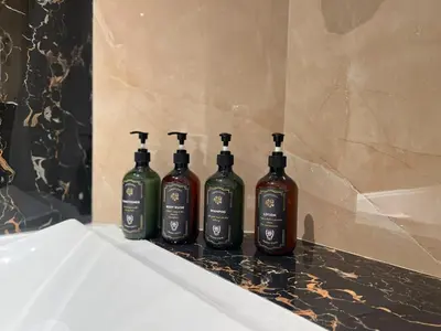 a group of four bottles of wine sitting on a counter at Trophy - Sky High Haven Suite in Dubai
