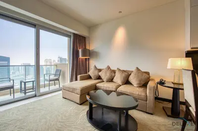 a living room with a couch and a large window at Lush 1 BR at The Address Residences Dubai Marina by Deluxe Holiday Homes in Dubai