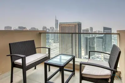 two chairs and a table on a balcony with a view at Lush 1 BR at The Address Residences Dubai Marina by Deluxe Holiday Homes in Dubai