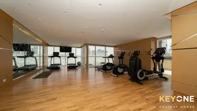 a gym with treadmills and elliptical machines at Carson Elegant Living in One Bedroom in Dubai