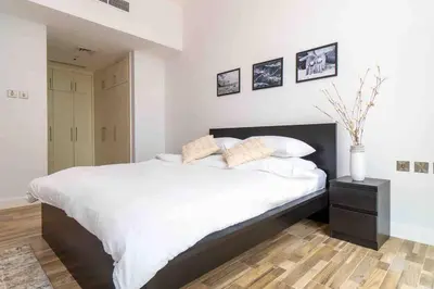 a bedroom with a large bed with white sheets and pillows at Unique 3BR DUPLEX Apartment with Marina Views in Dubai