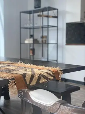 a table with a chair next to a table with a shelf at Unique 3BR DUPLEX Apartment with Marina Views in Dubai