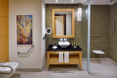 a bathroom with a sink and a shower at Marriott Hotel Al Jaddaf, Dubai in Dubai