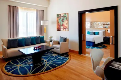a living room with a couch and a bed at Marriott Hotel Al Jaddaf, Dubai in Dubai
