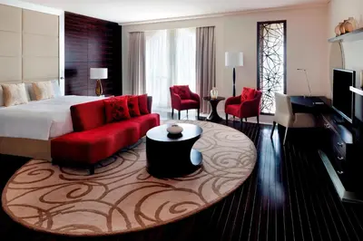 a hotel room with a bed and a red couch at Marriott Hotel Al Jaddaf, Dubai in Dubai