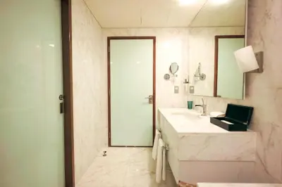 a bathroom with a sink and a shower and a mirror at FAHH - Superior 1BHK Address Dubai Mall Residences in Dubai