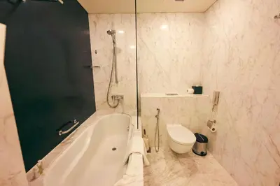 a bathroom with a shower and a tub and a toilet at FAHH - Superior 1BHK Address Dubai Mall Residences in Dubai