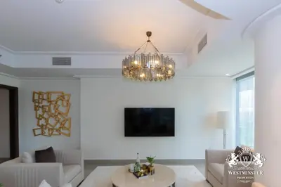 a living room with a chandelier hanging from the ceiling at Westminster Opera Burj Khalifa in Dubai