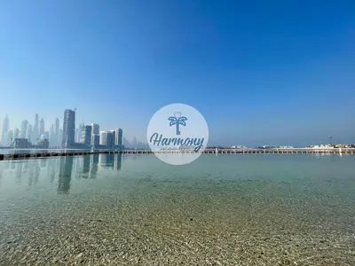 a sign over the water with a city in the background at Harmony Vacation Homes - North Residence in Dubai