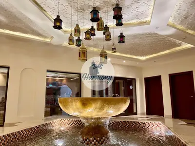 a large gold bowl in a lobby with a chandelier at Harmony Vacation Homes - North Residence in Dubai