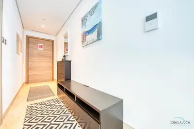 a hallway with a console table and a door at Airy Studio in Studio One Dubai Marina by Deluxe Holiday Homes in Dubai