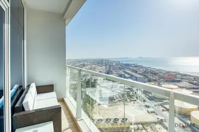 a balcony with a view of the ocean at Airy Studio in Studio One Dubai Marina by Deluxe Holiday Homes in Dubai