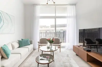 a living room with a couch and a table at Frank Porter - Belgravia 3 in Dubai